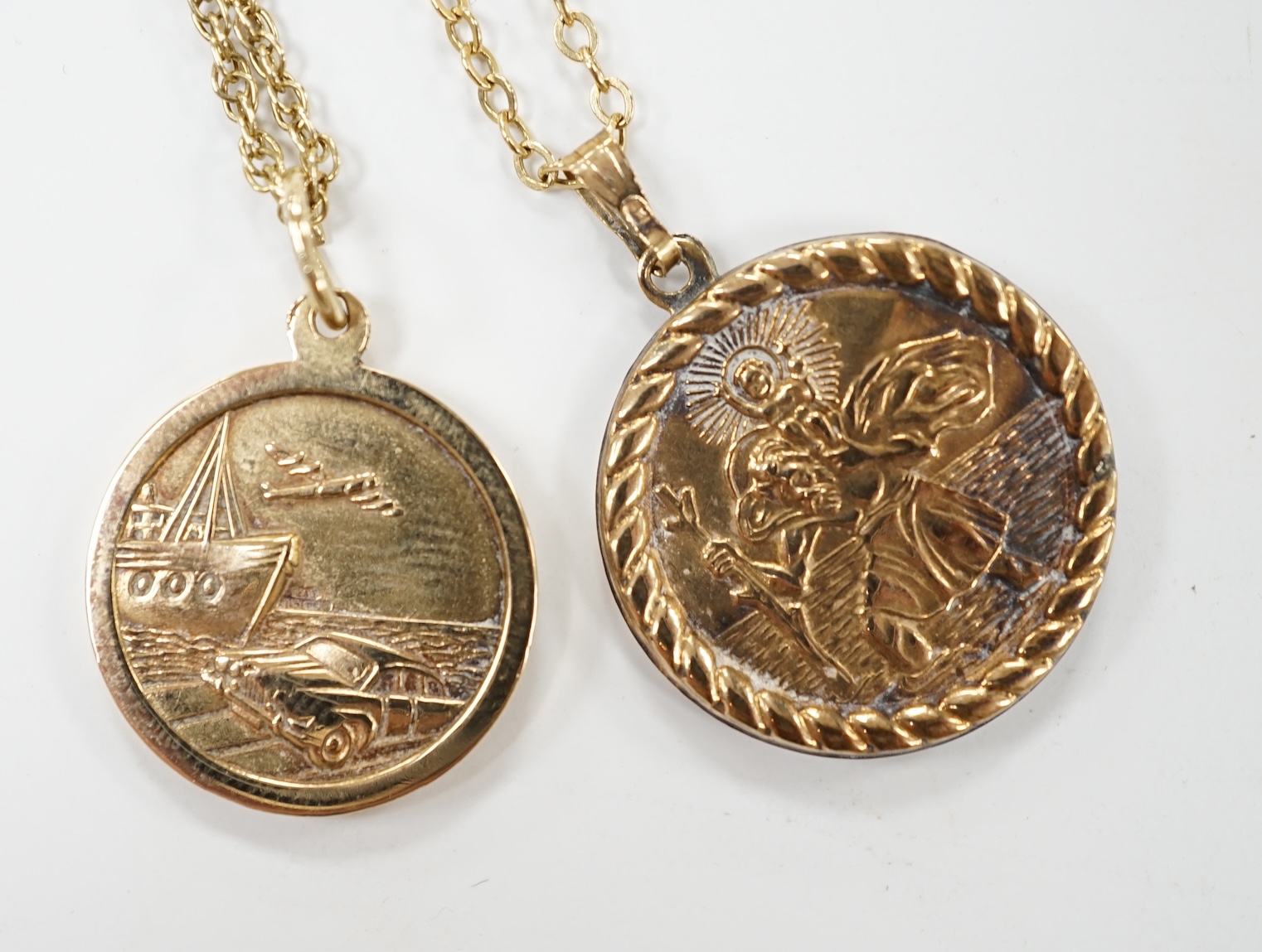 Two yellow metal St Christopher pendants, on 9k chains. Condition - poor to fair